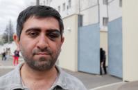 Armenian citizen Vartan Grigoryan poses for a picture outside a detention centre in Minsk