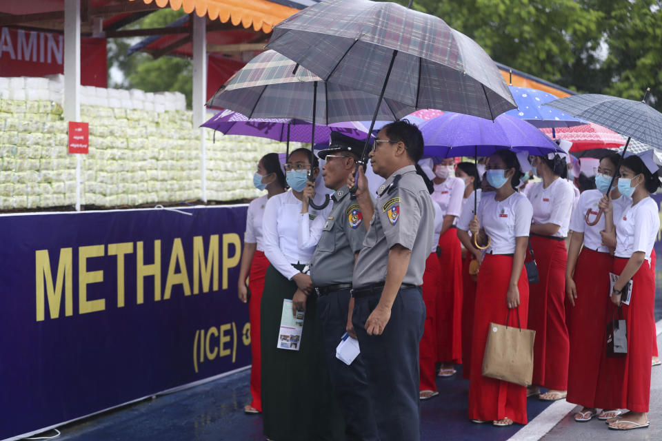 Teachers and students from Myanmar Nursing University watch seized illegal narcotics displayed during a destruction ceremony to mark International Day against Drug Abuse and Illicit Trafficking on the outskirts of Yangon, Myanmar, Monday, June 26, 2023.(AP Photo/Thein Zaw)