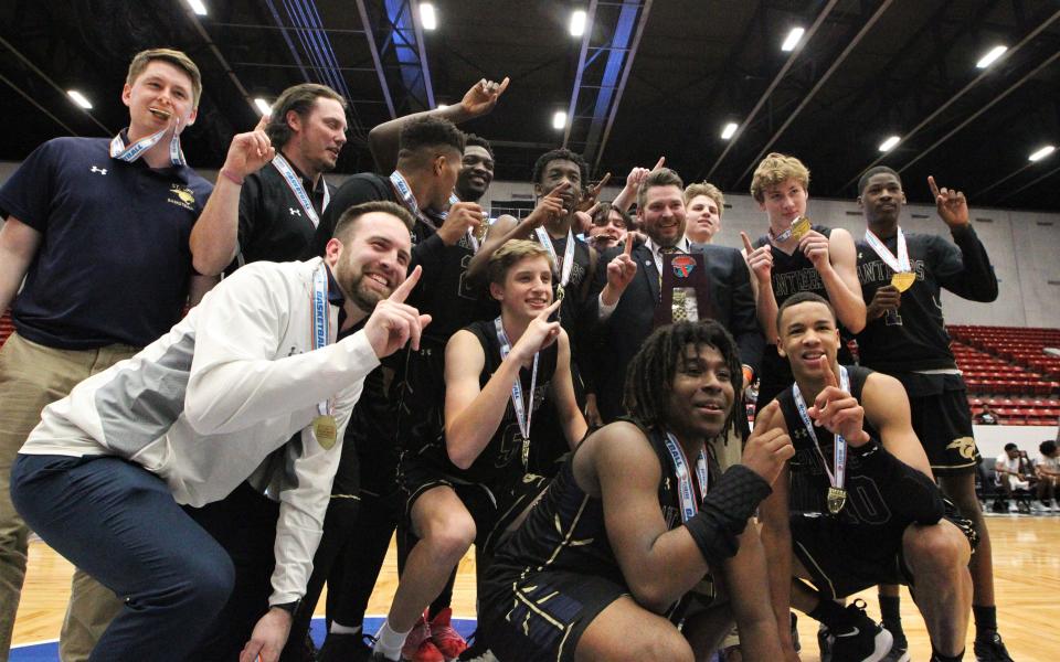 St. John Paul II's boys basketball team celebrates a 50-48 overtime victory against Orlando Christian Prep to capture a Class 3A state championship at the RP Funding Center in Lakeland on Tuesday.