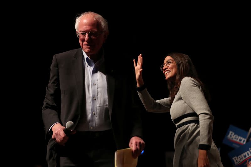 Democratic 2020 U.S. presidential candidate arrives at a campaign rally while Rep. Alexandria Ocasio-Cortez waves in Ames, Iowa