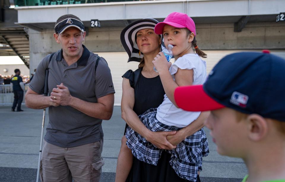 Brian and Laura Petraits and their children Noel, 5, and Neil, 7, walk around near the pits before the 106th running of the Indianapolis 500 on Sunday, May 29, 2022, at Indianapolis Motor Speedway.