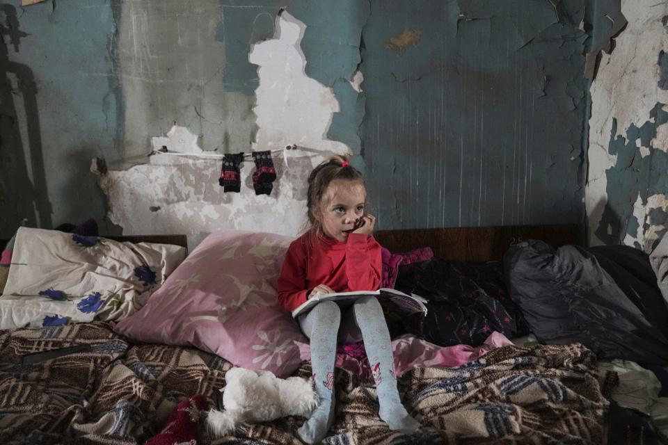 A girl sits in the improvised bomb shelter in Mariupol, Ukraine, Monday, March 7, 2022. (AP Photo/Evgeniy Maloletka)