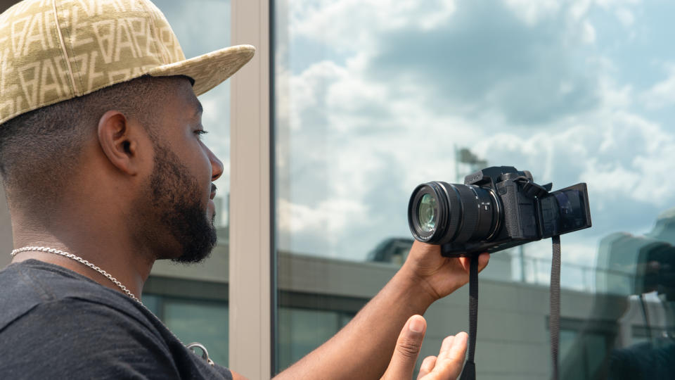 Panasonic Lumix S5 IIX being held by DCW reviewer Jon Devo