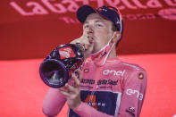 Britain's Tao Geoghegan Hart celebrates on the podium after winning the Giro d'Italia cycling race, in Milan, Italy, Sunday, Oct. 25, 2020. (AP Photo/Luca Bruno)