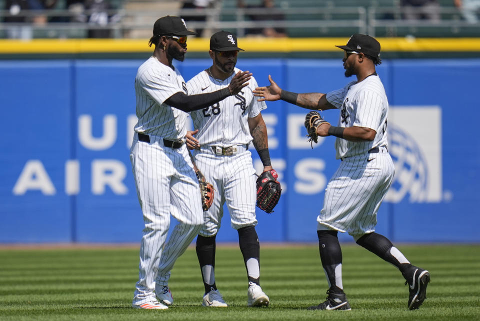 Chicago White Sox's, from left, Luis Robert Jr., Tommy Pham and Corey Julks celebrate the team's 3-1 win over the Minnesota Twins following the first baseball game of a doubleheader, Wednesday, July 10, 2024, in Chicago. (AP Photo/Erin Hooley)