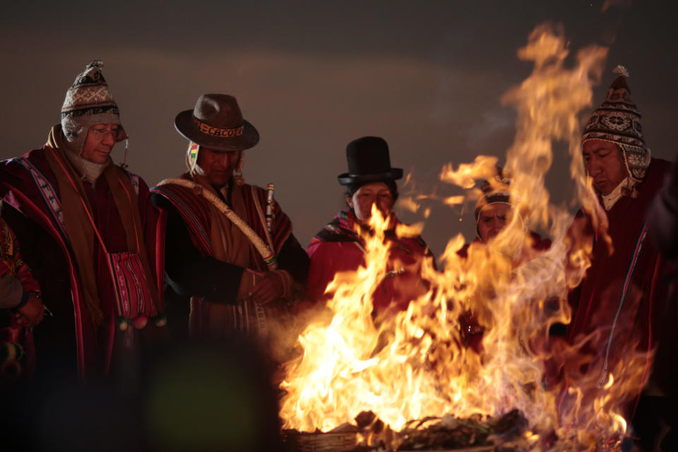 President of Bolivia Luis Arce (left) stands next to a fire as part of a ritual to celebrate winter solstice on June 21, 2022 in Tiwanaku, Bolivia.  / Credit: Getty Images