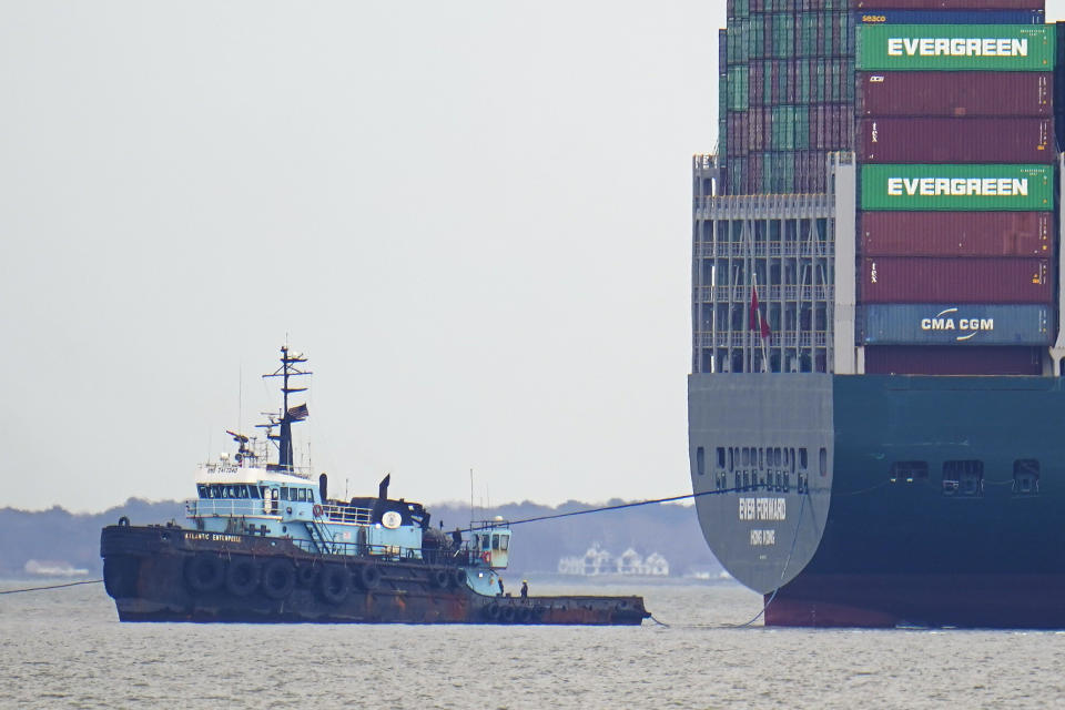 The tugboat Atlantic Enterprise, left, pulls the container ship Ever Forward, which ran aground, as crews continued for a second day to attempt to refloat the ship, Wednesday, March 30, 2022, in Pasadena, Md. (AP Photo/Julio Cortez)