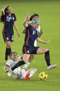 United States midfielder Julie Ertz (8) and Argentina midfielder Clarisa Huber, below, compete for a ball during the first half of a SheBelieves Cup women's soccer match, Wednesday, Feb. 24, 2021, in Orlando, Fla. (AP Photo/Phelan M. Ebenhack)