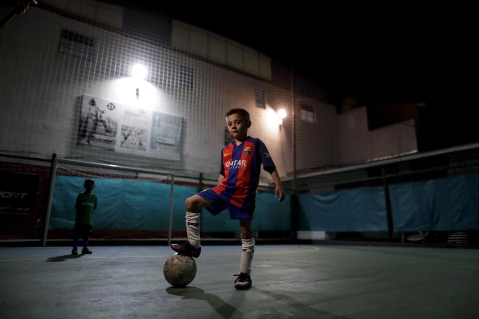 En esta foto del 11 de noviembre de 2016, Benjamín Palandella posa para una foto con su camisa del Barcelona, que lleva el número 10 de Messi, después de un juego de entrenamiento en Buenos Aires, Argentina. Ramón Maddoni, entrenador de Palandella, dijo: “Benjamín es distinto porque ya toca para atrás y maneja las dos piernas”. (AP Foto/Natacha Pisarenko)