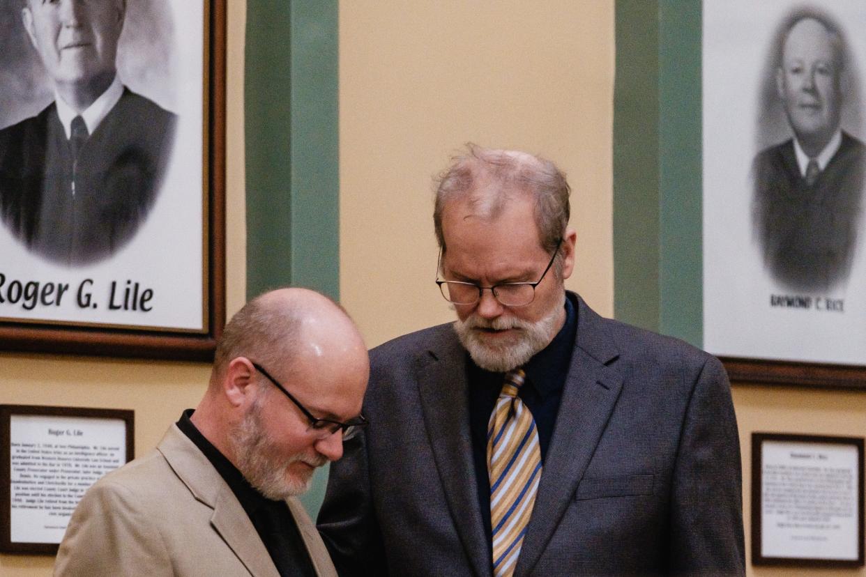 Jeffrey A. Stearns, left, prays with his pastor before Stearns' sentencing hearing, Friday, April 19 at the Tuscarawas County Courthouse.