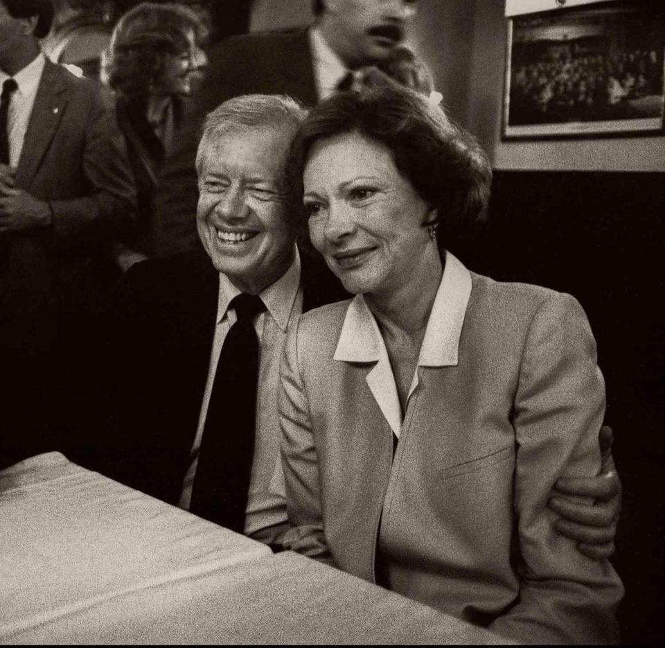 President Jimmy Carter and former First Lady Rosalynn Carter pose for photographers during a book signing event, San Francisco, California, 1987. Several members of the Secret Service can be seen behind them. The couple were promoting their book, 'Everything to Gain: Making the Most of the Rest of Your Life'