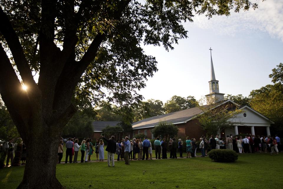 People wait in line to enter Maranatha Baptist Church for Sunday School class by former President Jimmy Carter on Aug. 23, 2015, in Plains, Ga. (AP Photo/David Goldman)