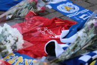 <p>Supporters pay tribute to the Leicester City owner after the crash which killed five people. Aaron Chown/PA Wire </p>