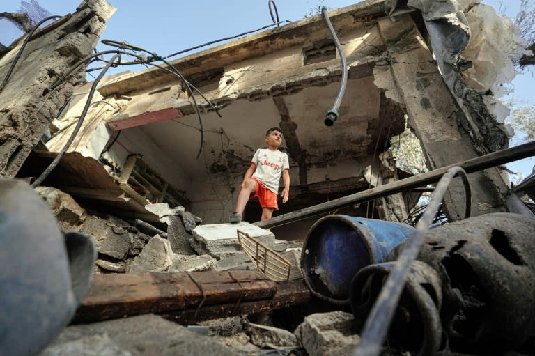 A Palestinian boy stands in a destroyed house in Gaza's Nuseirat area following Israeli bombardment overnight, on May 23, 2024 (Bashar TALEB)