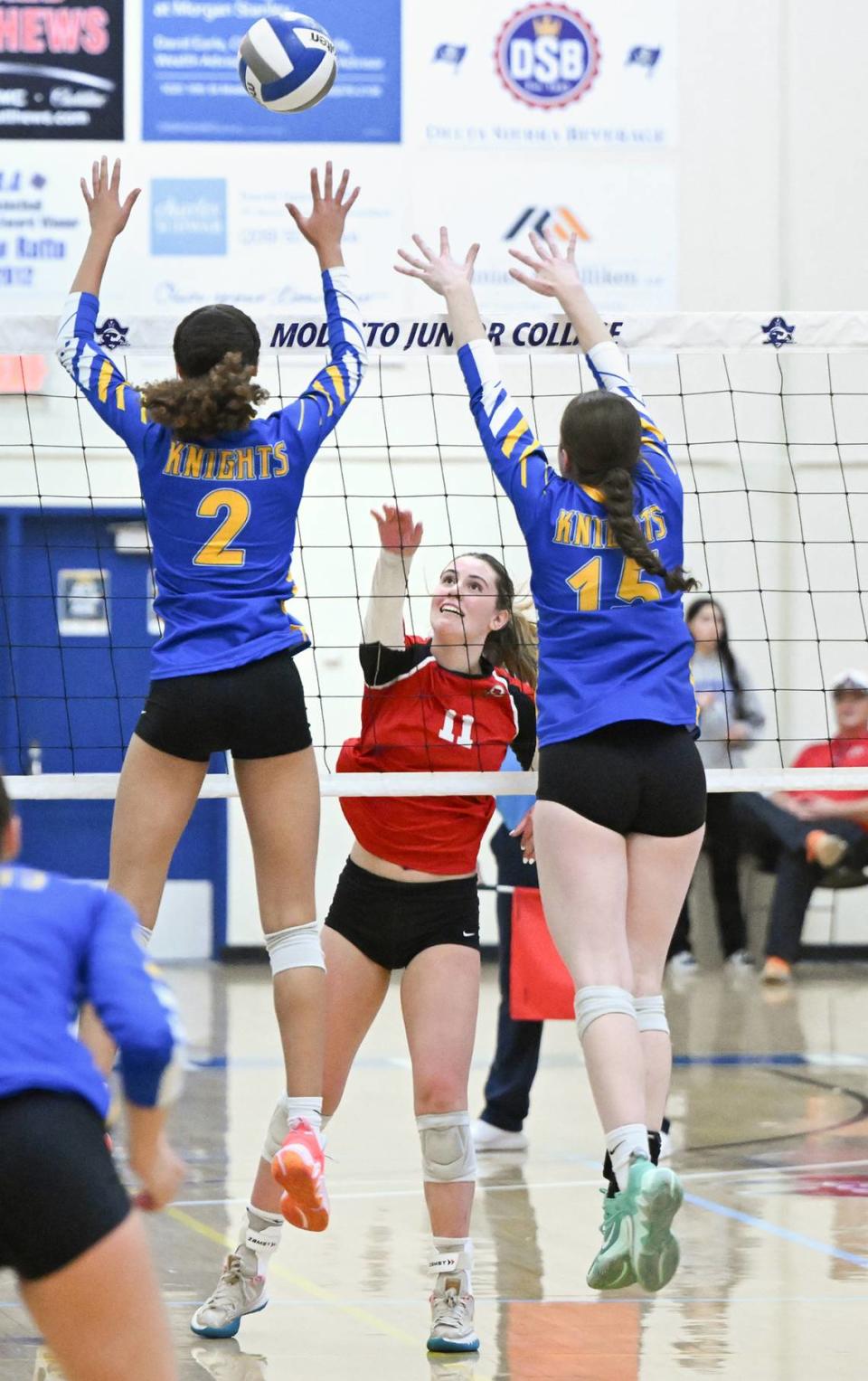 Ripon’s Adriana Dorn floats the ball over Ripon Christian’s Sydney Hoffman (2) and Maddie Yonker (15) during the Sac-Joaquin Section Division IV championship match at Modesto Junior College in Modesto, Calif., Saturday, Nov. 4, 2023. Ripon Christian won the match 3-0. Andy Alfaro/aalfaro@modbee.com