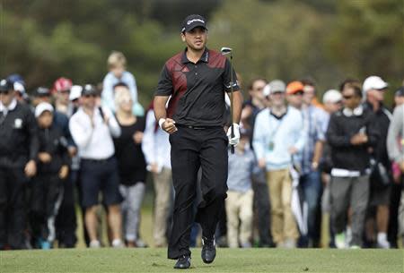 Australia's Jason Day reacts after playing his approach to the 18th green on his way to winning the World Cup of Golf at The Royal Melbourne Golf Club in Melbourne November 24, 2013. REUTERS/Brandon Malone