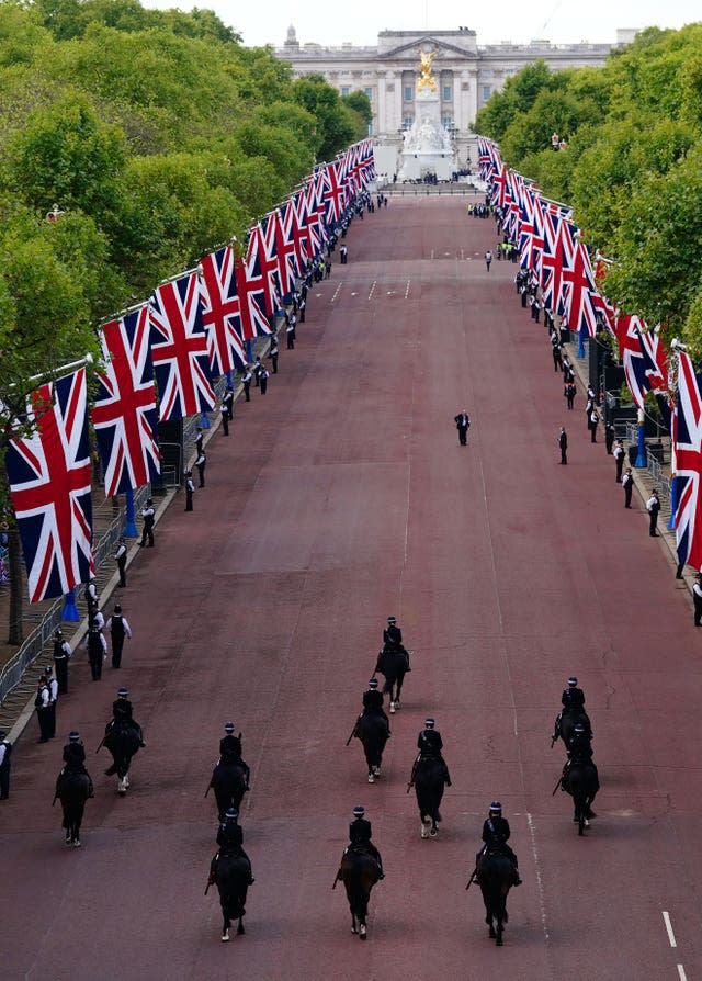 Mounted police pass along The Mall ahead of the ceremonial procession of the coffin of Queen Elizabeth II from Buckingham Palace to Westminster Hall 