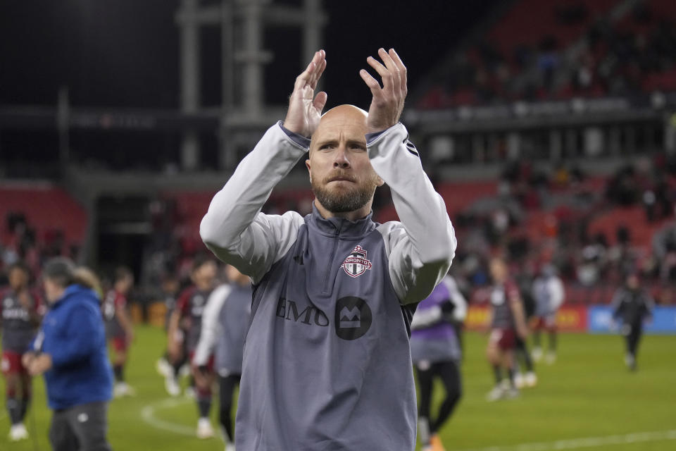 Toronto FC midfielder Michael Bradley applauds to the crowd after an MLS soccer match against Orlando City in Toronto on Saturday, Oct. 21, 2023. The match was Bradley's final game of his MLS career. (Nathan Denette/The Canadian Press via AP)