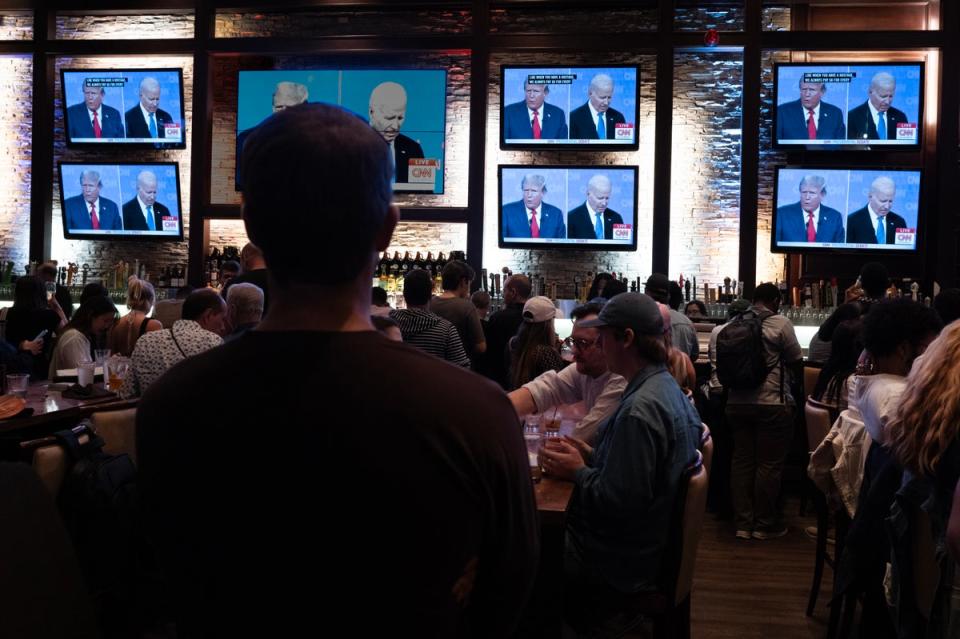 Many viewers took to social media to voice their disappointment around the debate’s handling by CNN. Pictured:  Customers at the Old Town Pour House in Chicago watch the debate (Getty Images)