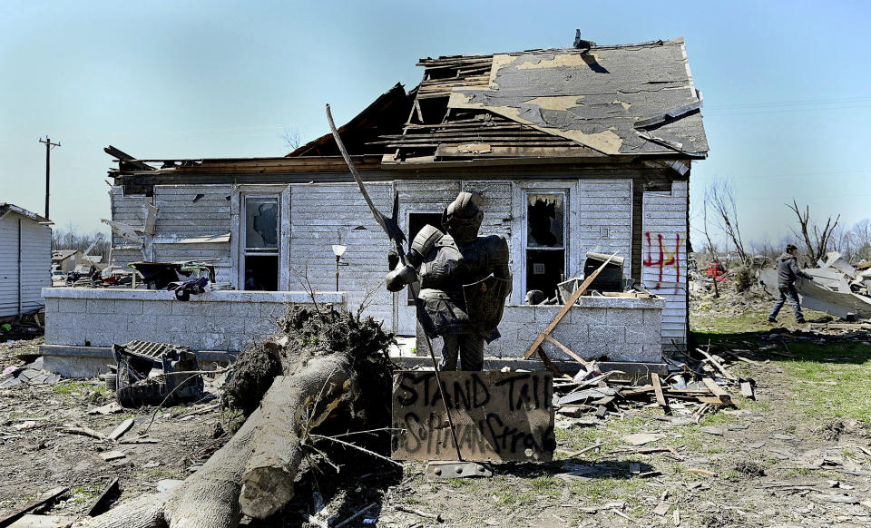 A statue of a knight stands in one of the city's neighborhoods that was damaged by a recent tornado on Monday, April 3, 2023, in Sullivan, Ind. (Joseph C. Garza/The Tribune-Star via AP)
