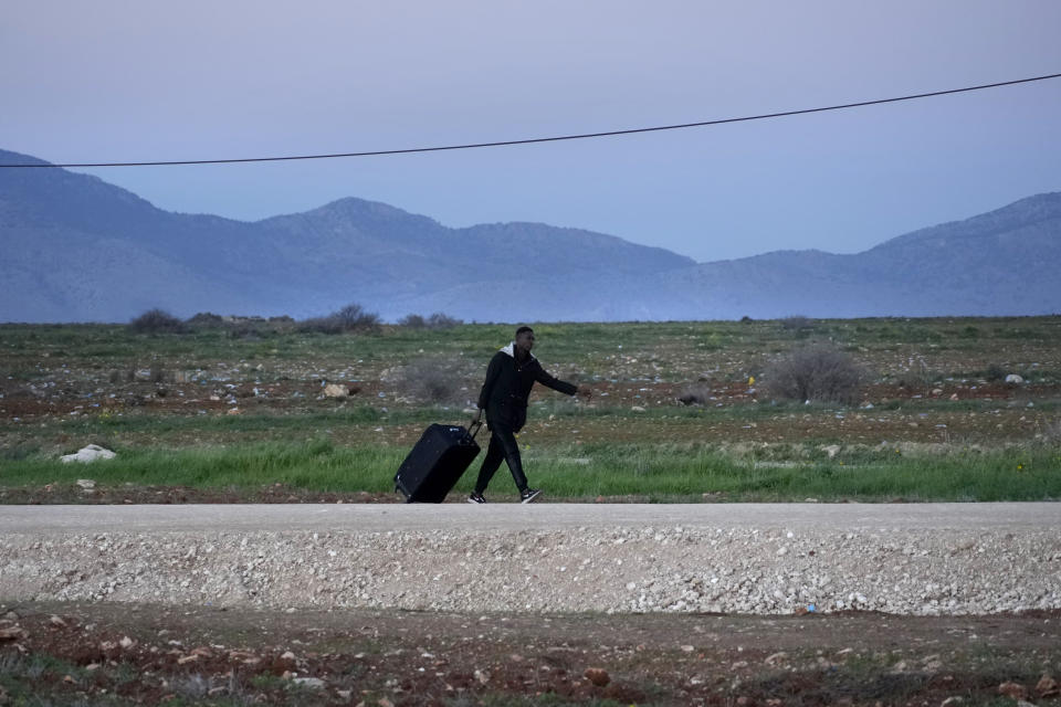 A migrant walks near Pournara refugee camp on the outskirts of divided capital Nicosia, Cyprus, Saturday, Jan. 28, 2023. Cypriots are voting Sunday for a new president who they’ll expect to decisively steer the small island nation through shifting geopolitical sands and uncertain economic times that have become people's overriding concern, eclipsing stalemated efforts to remedy the country’s ethnic division. (AP Photo/Petros Karadjias)