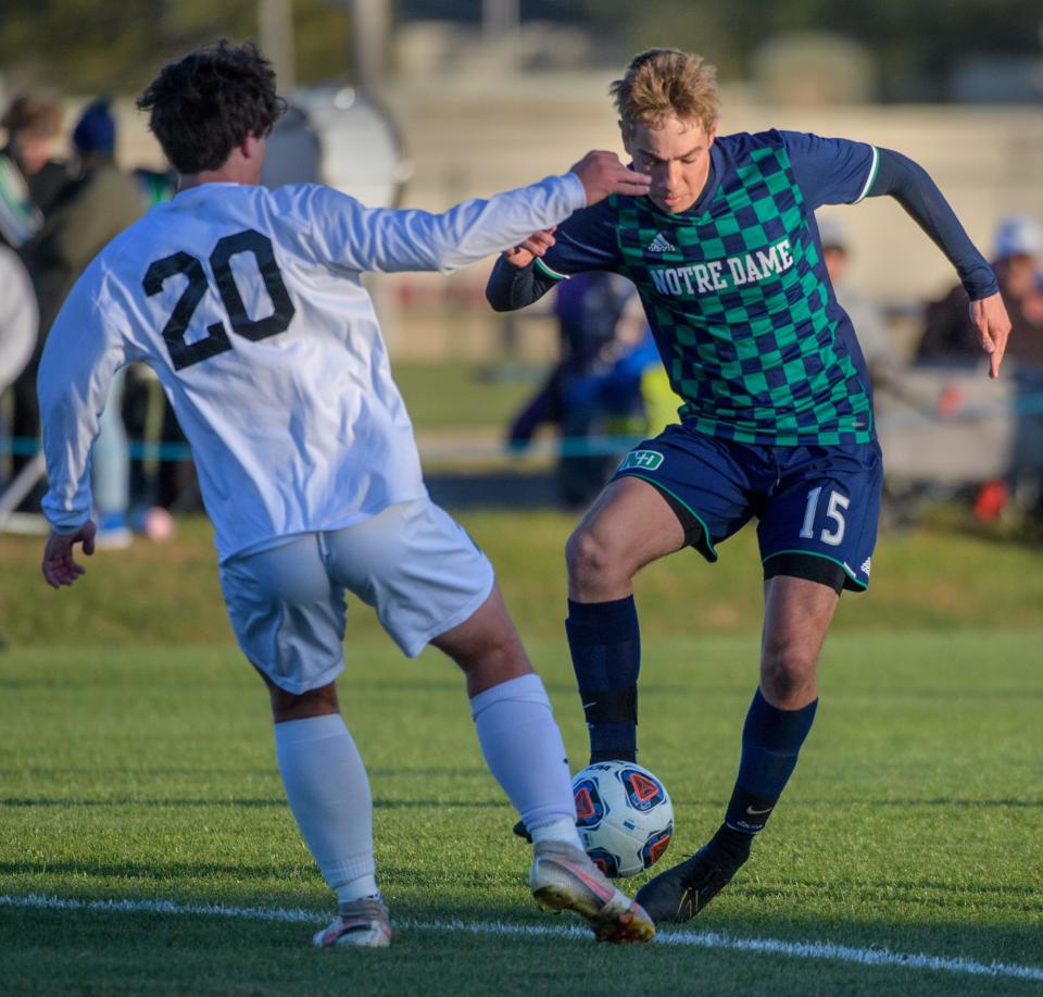 Peoria Notre Dame's Andrew Bonham (15) moves the ball around Richwoods' Leo Day in the first half of their Class 2A regional soccer match Tuesday, Oct. 18, 2022 at PND High School. The Irish advanced with a 6-0 win.