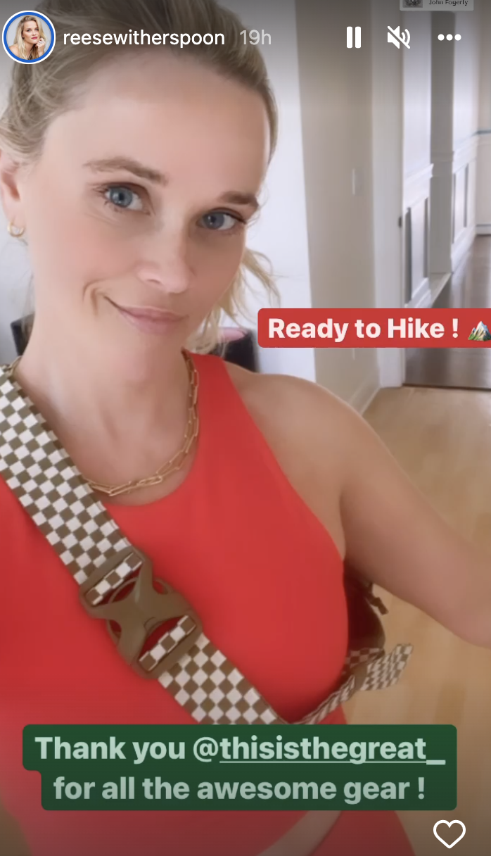 reese witherspoon in red sleeveless tank top and checkered bag from The Great + Eddie Bauer's limited-edition capsule collection 