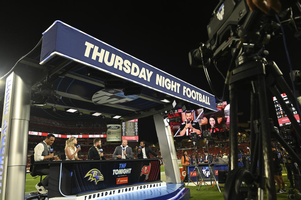 The Thursday Night Football crew, from left, Tony Gonzalez, Charissa Thompson, Ryan Fitzpatrick, Andrew Whitworth, and Richard Sherman, are shown before an NFL football game between the Baltimore Ravens and Tampa Bay Buccaneers Thursday, Oct. 27, 2022, in Tampa, Fla. (AP Photo/Jason Behnken)
