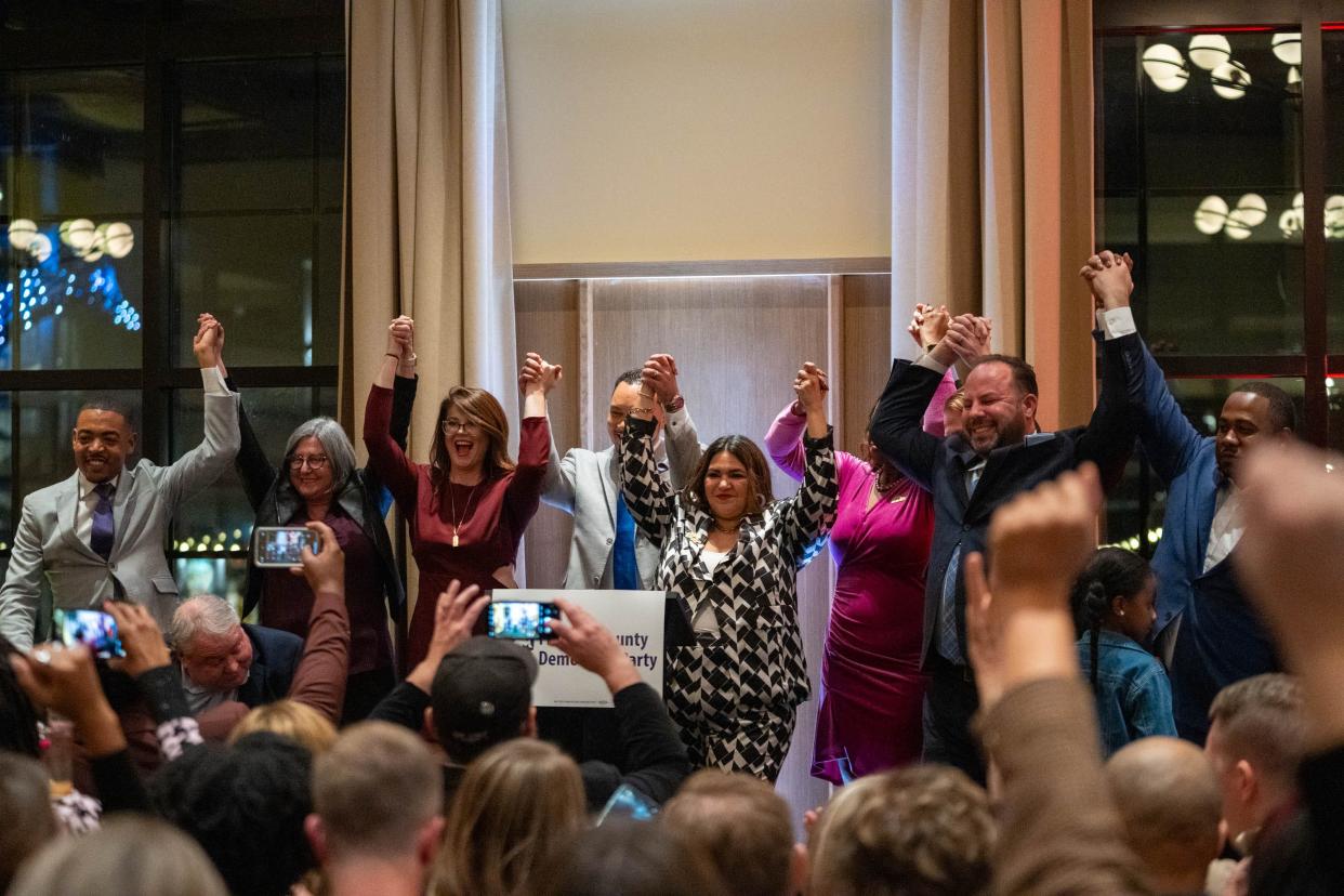 Columbus City Councilmembers raise their arms in celebration of election results on Tuesday, Nov. 7, 2023, at the Franklin County Democratic Watch Party event at the Junto Hotel.