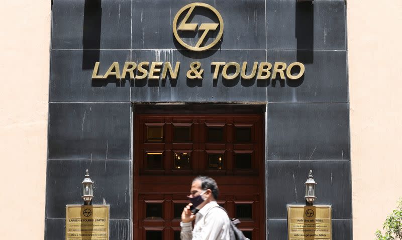 FILE PHOTO: A man walks past the Larsen and Toubro (L&T) head office in Mumbai