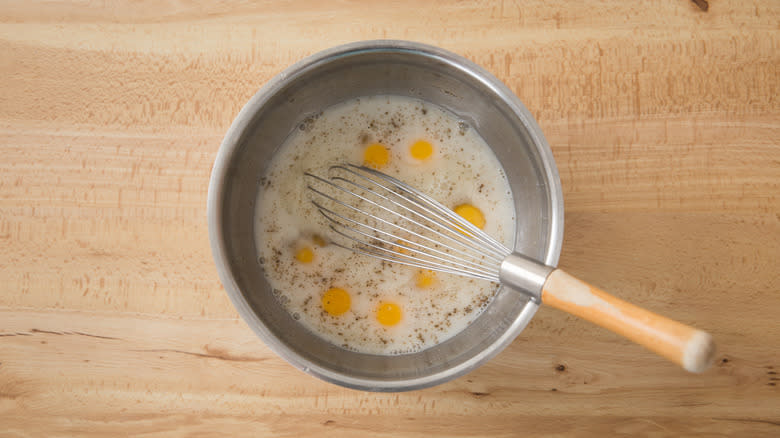 whisking egg and milk mixture 