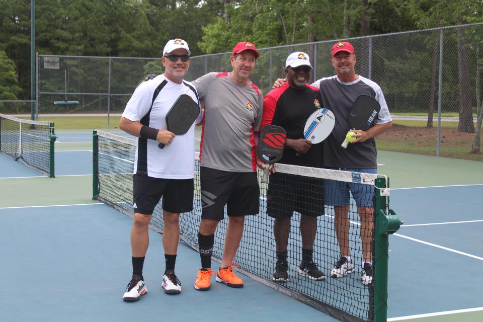 From left to right, Wayne Bigg, Dean Matt, Wilmington City Council member Clifford Barnett and Jimmy Santangelo pose before a pickleball game at Northern Regional Park in Castle Hayne on Thursday. Matt is attempting to play a game of pickleball in each of the 48 contiguous U.S. states within a span of 26 days.