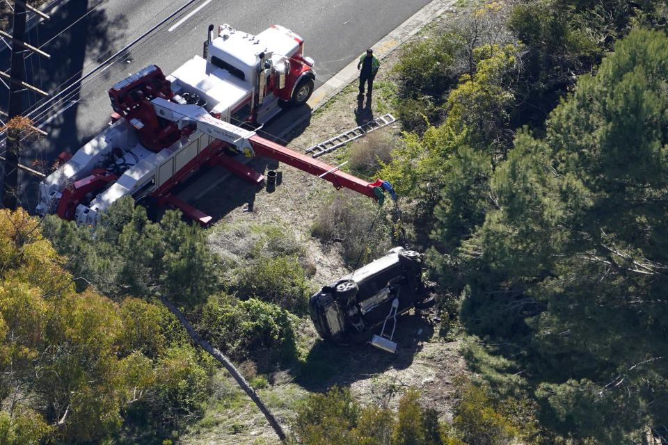 A vehicle rests on its side after a rollover accident involving golfer Tiger Woods Tuesday, Feb. 23, 2021, in Rancho Palos Verdes, Calif., a suburb of Los Angeles. Woods suffered leg injuries in the one-car accident and was undergoing surgery, authorities and his manager said. (AP Photo/Mark J. Terrill)