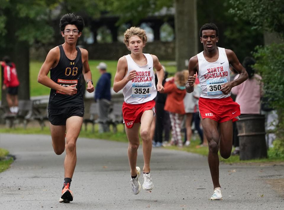 North Rockland's Ryan Tuohy, center, Claudel Chery, right, and Oyster Bay's Chris Tardugno lead in the Boys Varsity B 3-mile run at the Suffern Invitational at Bear Mountain State Park in Tomkins Cove on Saturday, September 23, 2023.