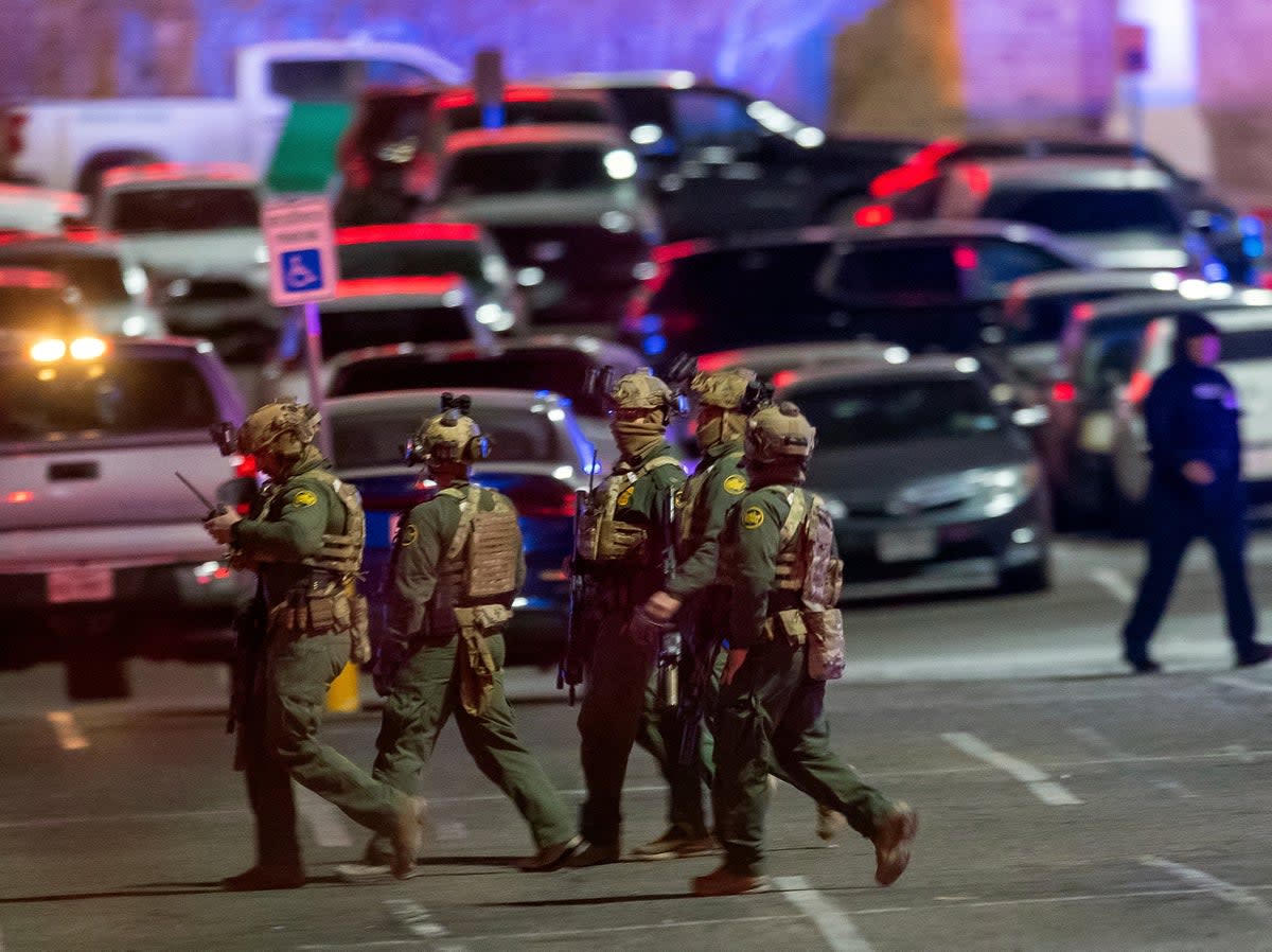 Law enforcement agents walk in the parking lot of a shopping mall in El Paso, Texas (AP)