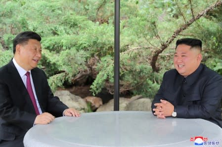 Chinese President Xi Jinping and North Korean leader Kim Jong Un take a walk in Pyongyang