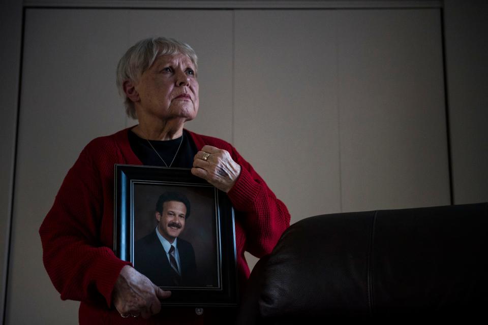 Chris Winokur poses for a portrait with a photo of her late husband, former Fort Collins City Councilman and Mayor, Robert Winokur, on Thursday, Jan. 31, 2019, in Estes Park, Colo.