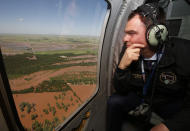 Oklahoma Gov. Kevin Stitt surveys flooding damage near Minco, Okla., from the air Tuesday, May 21, 2019, following heavy rains across the state. (AP Photo/Sue Ogrocki)