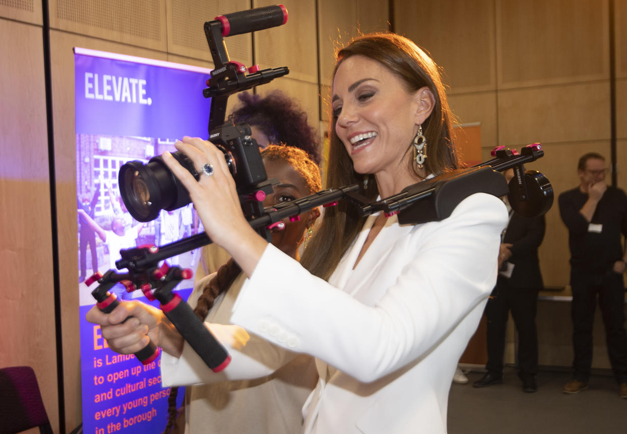 The Duchess of Cambridge holds a video camera while speaking to people from the Elevate initiative at Brixton House. (Getty Images)