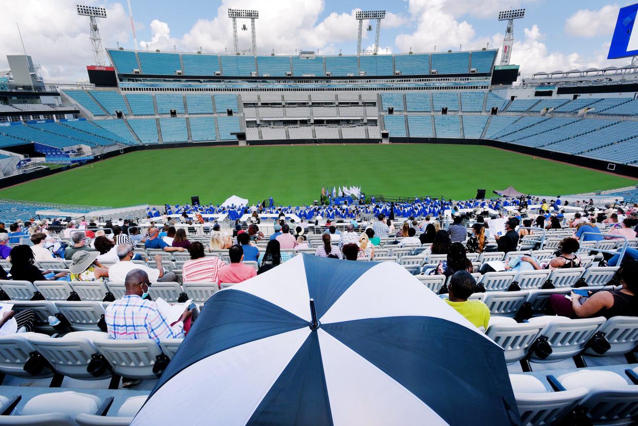 Spectators brought their own shade as they watched the graduation ceremony for the 2020 graduates of the Frank H. Peterson Academies of Technology from the stands of TIAA Bank Field. More ceremonies will be taking place there following delays during the pandemic.