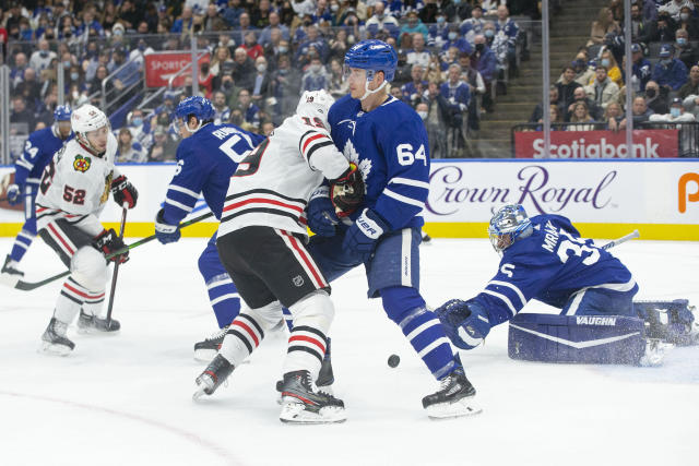 Chicago Blackhawks center Kirby Dach, right, celebrates his tying