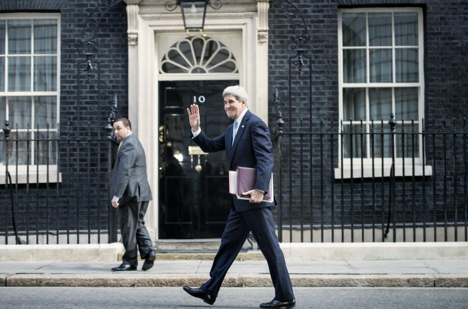 U.S. Secretary of State John Kerry waves to journalists as he arrives at Downing Street in central London on March 14, 2014, for a meeting with British Prime Minister David Cameron and Foreign Secretary William Hague. Kerry arrived in London on an 11th-hour mission to head off a possible Russian annexation of Crimea on the heels of a breakaway vote by the Ukrainian region. (Photo credit should read BRENDAN SMIALOWSKI/AFP/Getty Images)