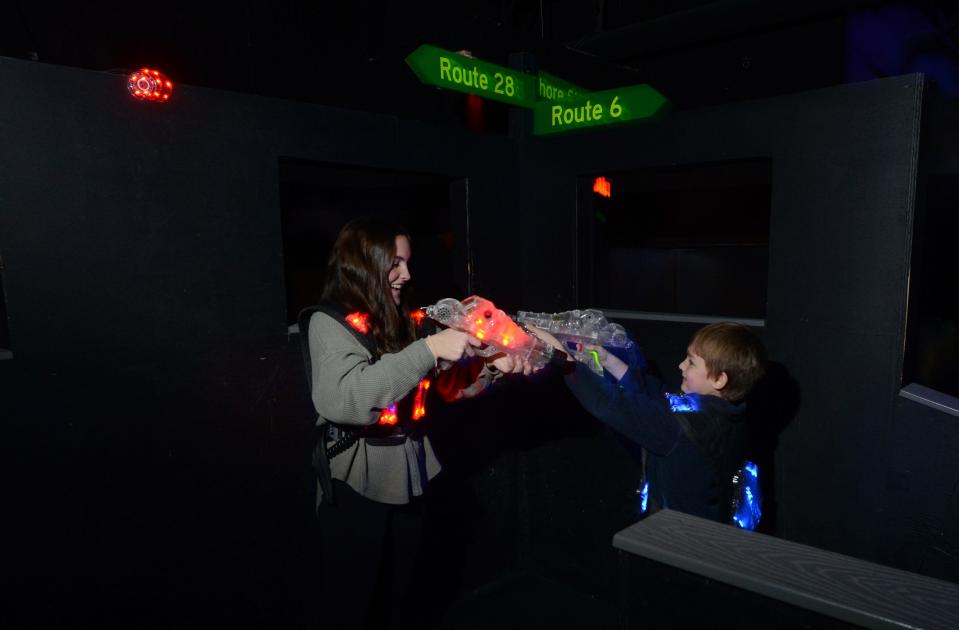 Red meets blue as Lilly Case, chases down a member of the blue squad at Ryan's Ten Pin Laser Tag at the Cape Cod Mall in Hyannis.