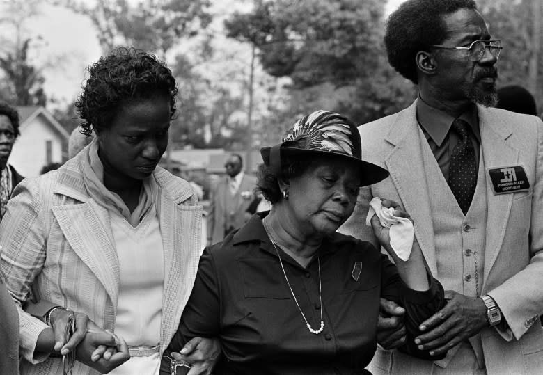 Beulah Donald (center) wipes tears from her eyes as she enters the funeral service for her 19-year-old son Michael Donald, who was killed by two Klansmen. The case would later spawn a $7 million civil judgment against the United Klans of America that bankrupted the hate group. (Mark Foley/Associated Press)