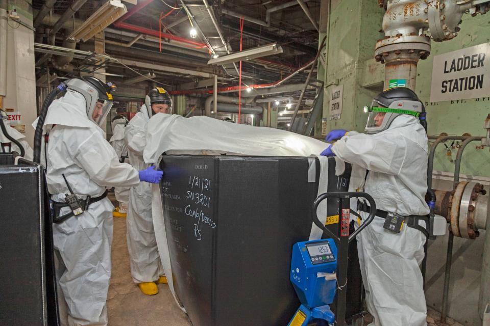 UCOR workers remove waste from Alpha-2 as part of deactivation work at the Y-12 National Security Complex at Oak Ridge.