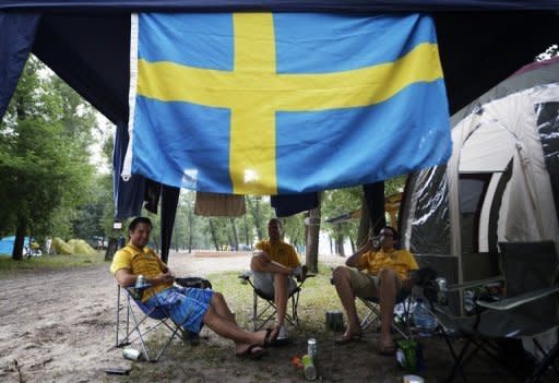 Swedish fans sit next to their tents at the campsite "Camp Sweden" in Kiev. Local municipal councillor Olexandre Davidenko was quoted in Ukrainska Pravda as saying: "I think the Swedes will come to regret their decision to camp there."