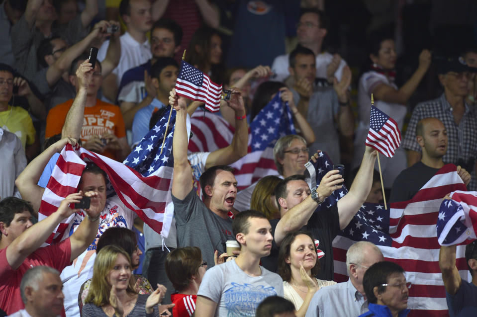 Fans celebrate with the US national flag as medallist US' Jacob Stephen Varner wins the Men's 96kg Freestyle gold medal match on August 12, 2012 during the wrestling event of the London 2012 Olympic Games.  AFP PHOTO / YURI CORTEZ        (Photo credit should read YURI CORTEZ/AFP/GettyImages)