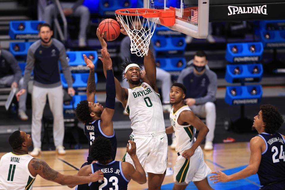 Baylor forward Flo Thamba shoots the ball against Villanova guard Justin Moore during a Sweet 16 matchup in the 2021 NCAA Tournament at Hinkle Fieldhouse.