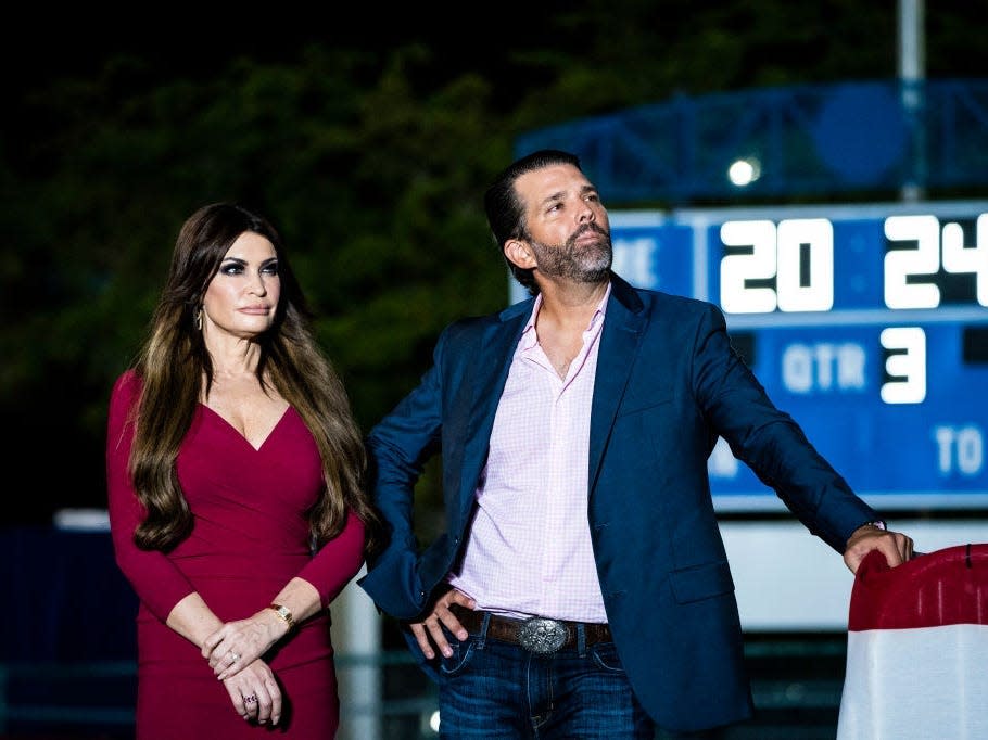 Kimberly Guilfoyle and Donald Trump Jr. watch Donald Trump speak at a Trump rally in Florida.