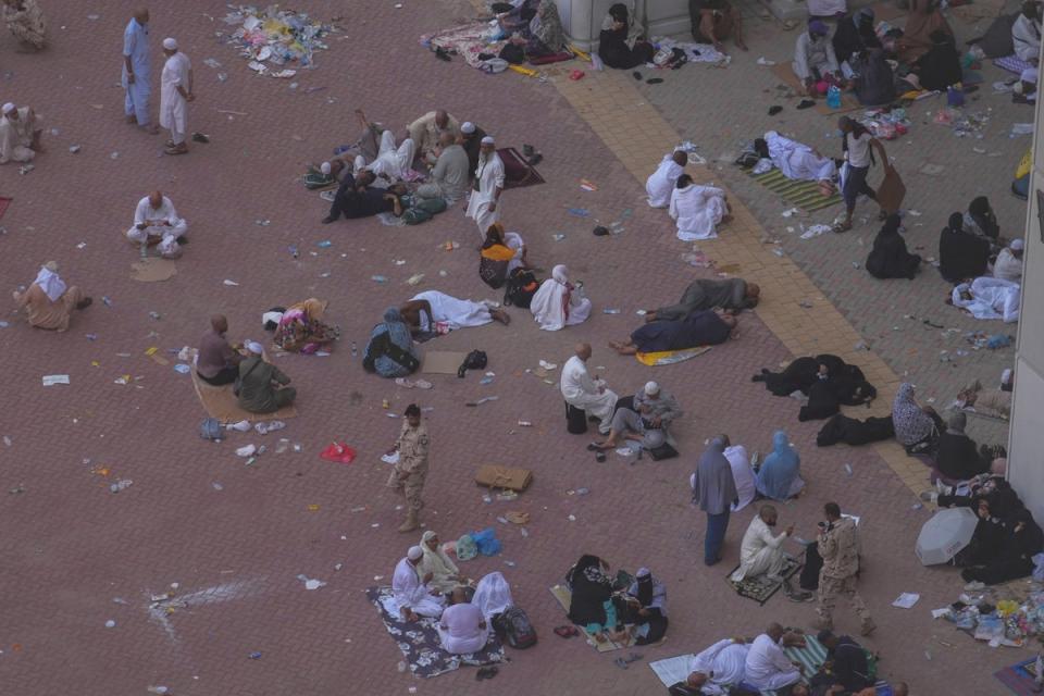 People rest after casting stones at pillars in the symbolic stoning of the devil, the last rite of Hajj (AP)